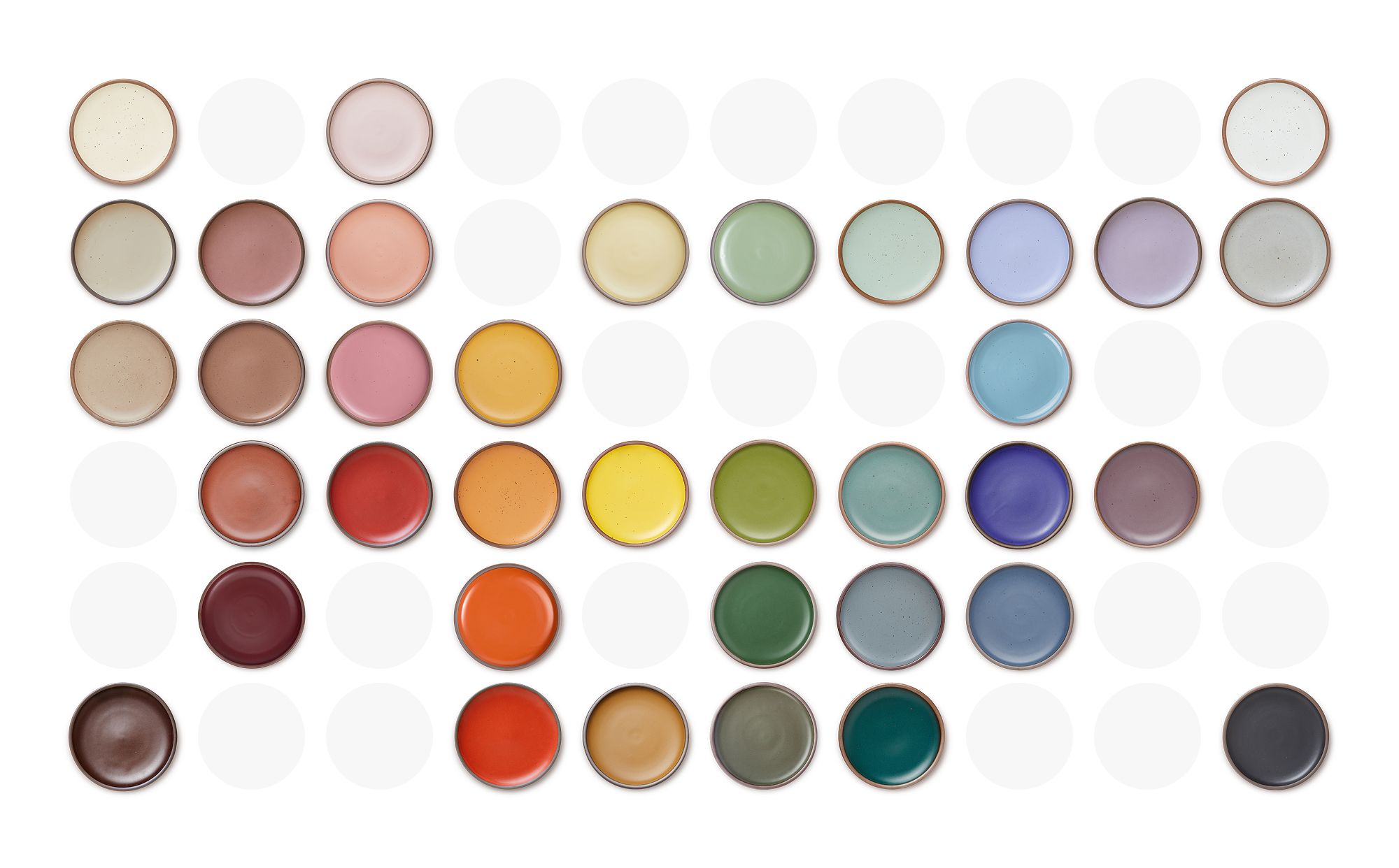 A graphic of ceramic plates in a rainbow of colors all laid out in a color map.