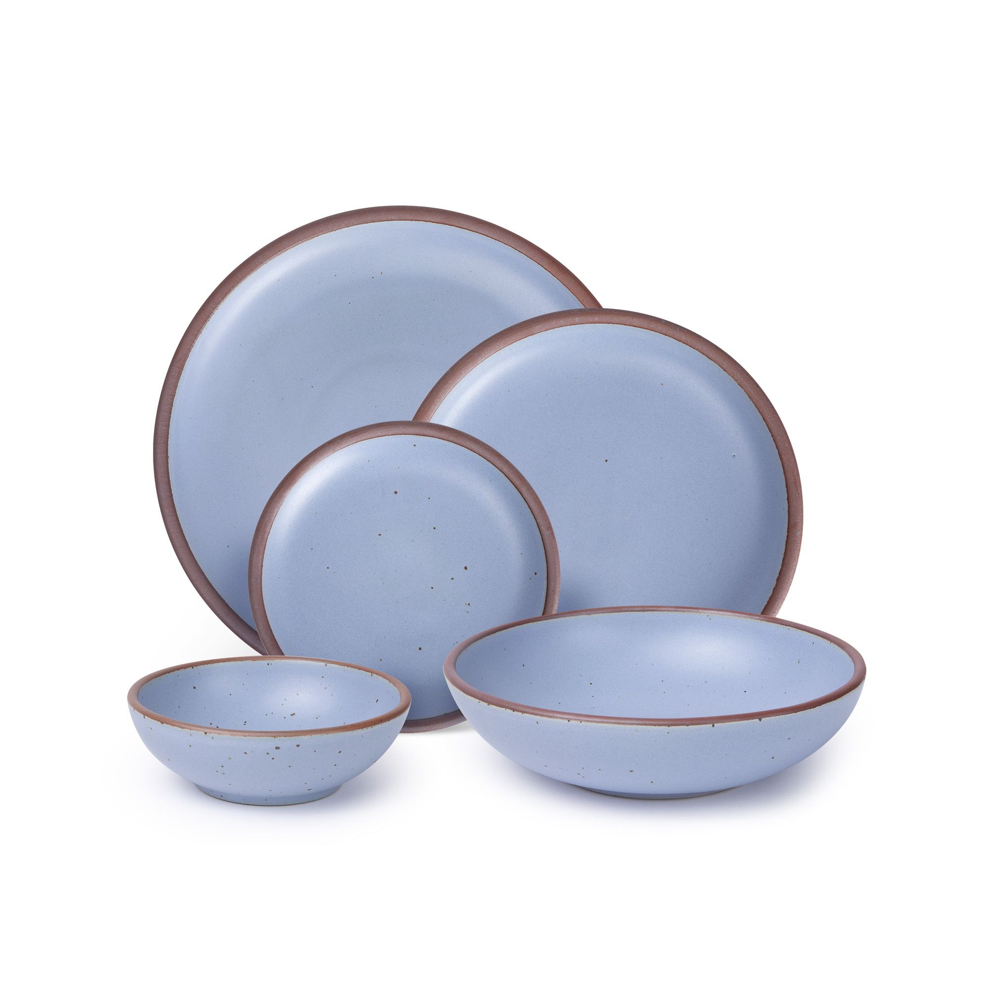 A breakfast bowl, everyday bowl, cake plate, side plate and dinner plate paired together in a periwinkle color featuring iron speckles