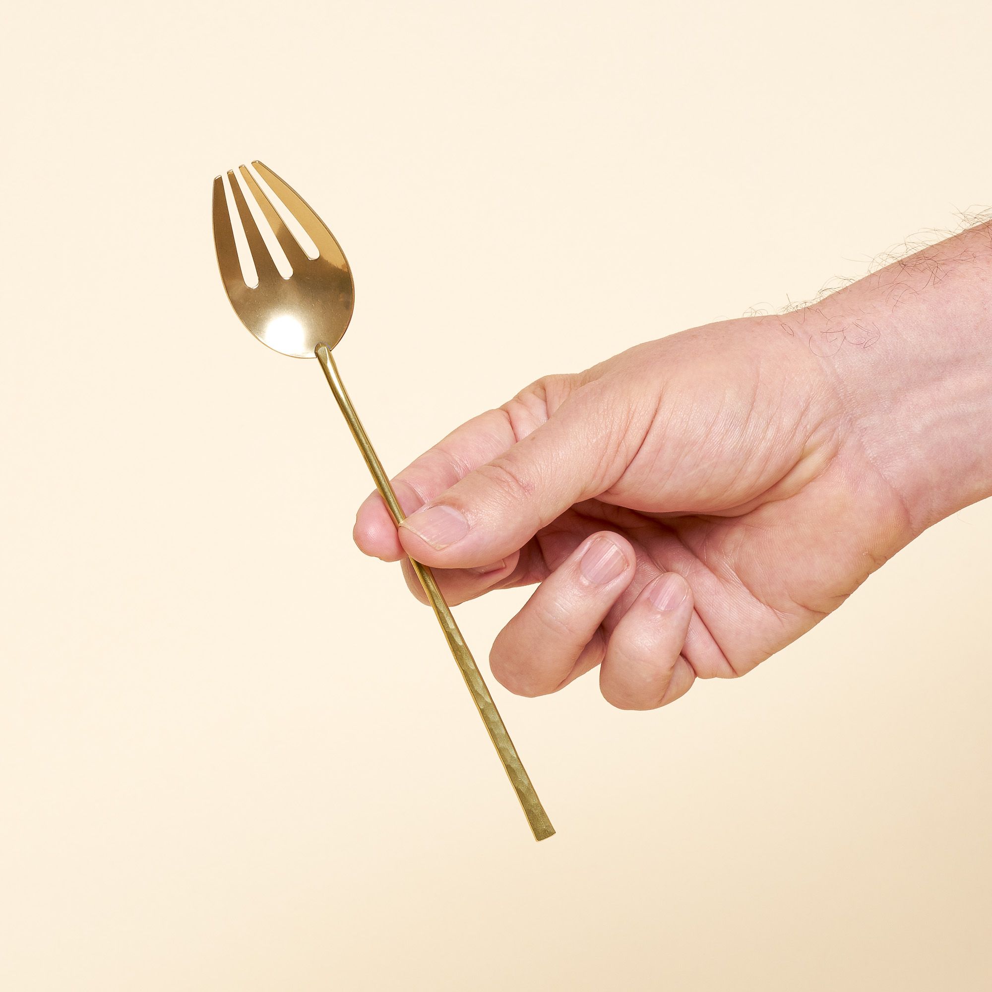 A serving fork with an elongated handle and unique sporky shape.