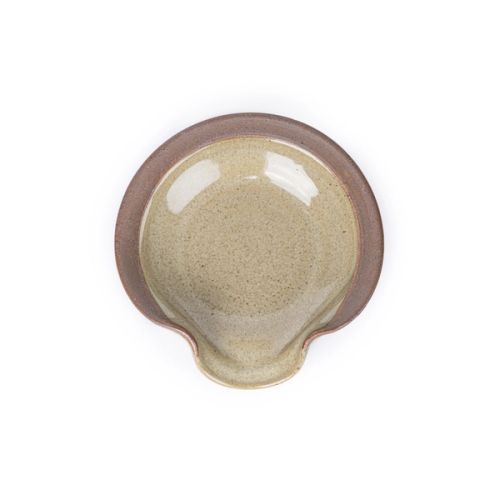 A circular ceramic spoon rest in a reflective grey-green color featuring iron speckles and unglazed ridge rim