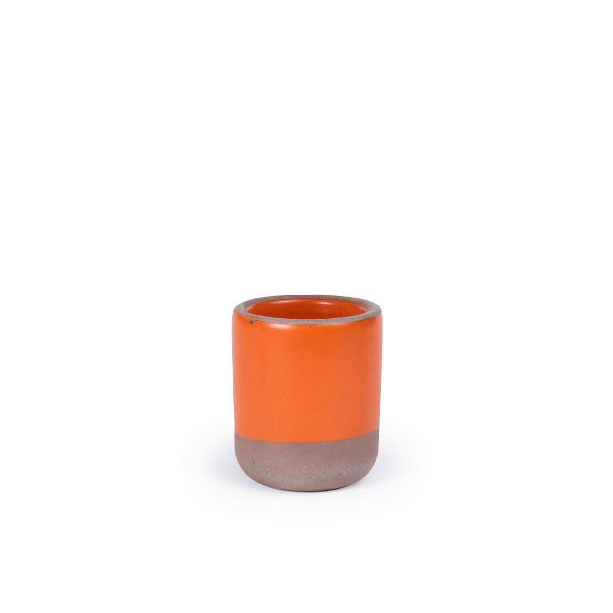 A small, short ceramic mug cup in a bold orange color featuring iron speckles and unglazed rim and bottom base.