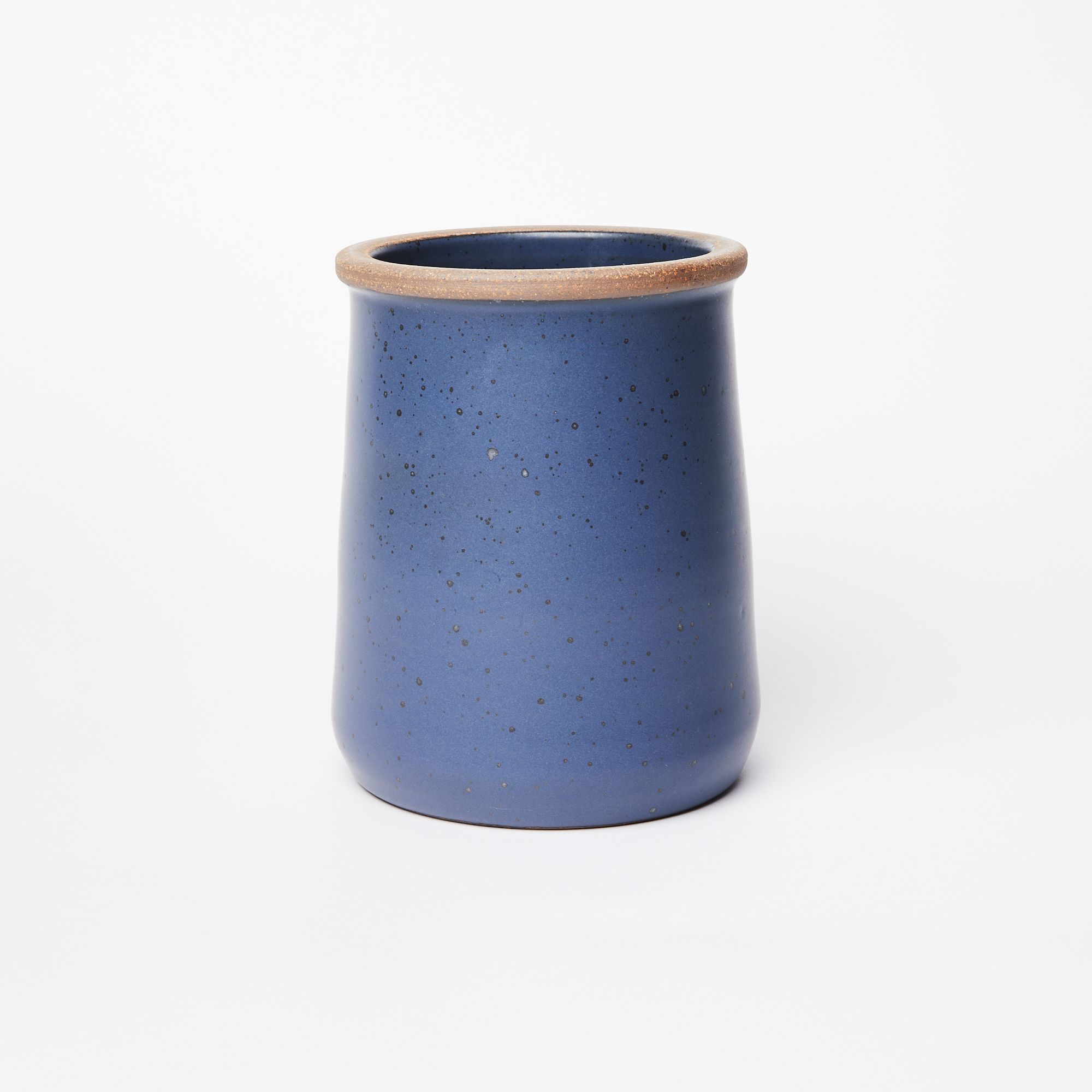 A cylindrical ceramic utensil crock in a muted navy color with an unglazed ridge rim.