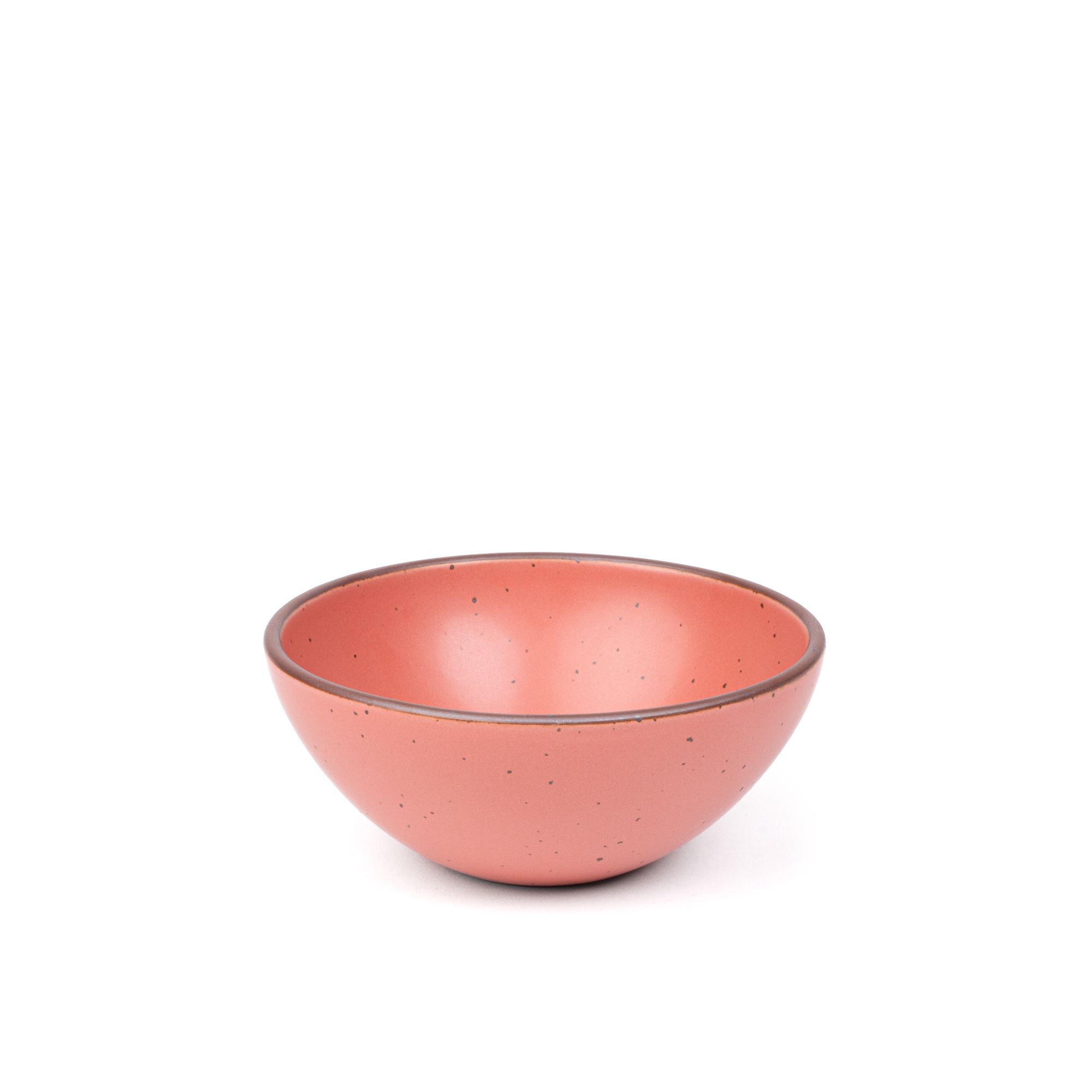 A medium rounded ceramic bowl in a watermelon pink color featuring iron speckles and an unglazed rim