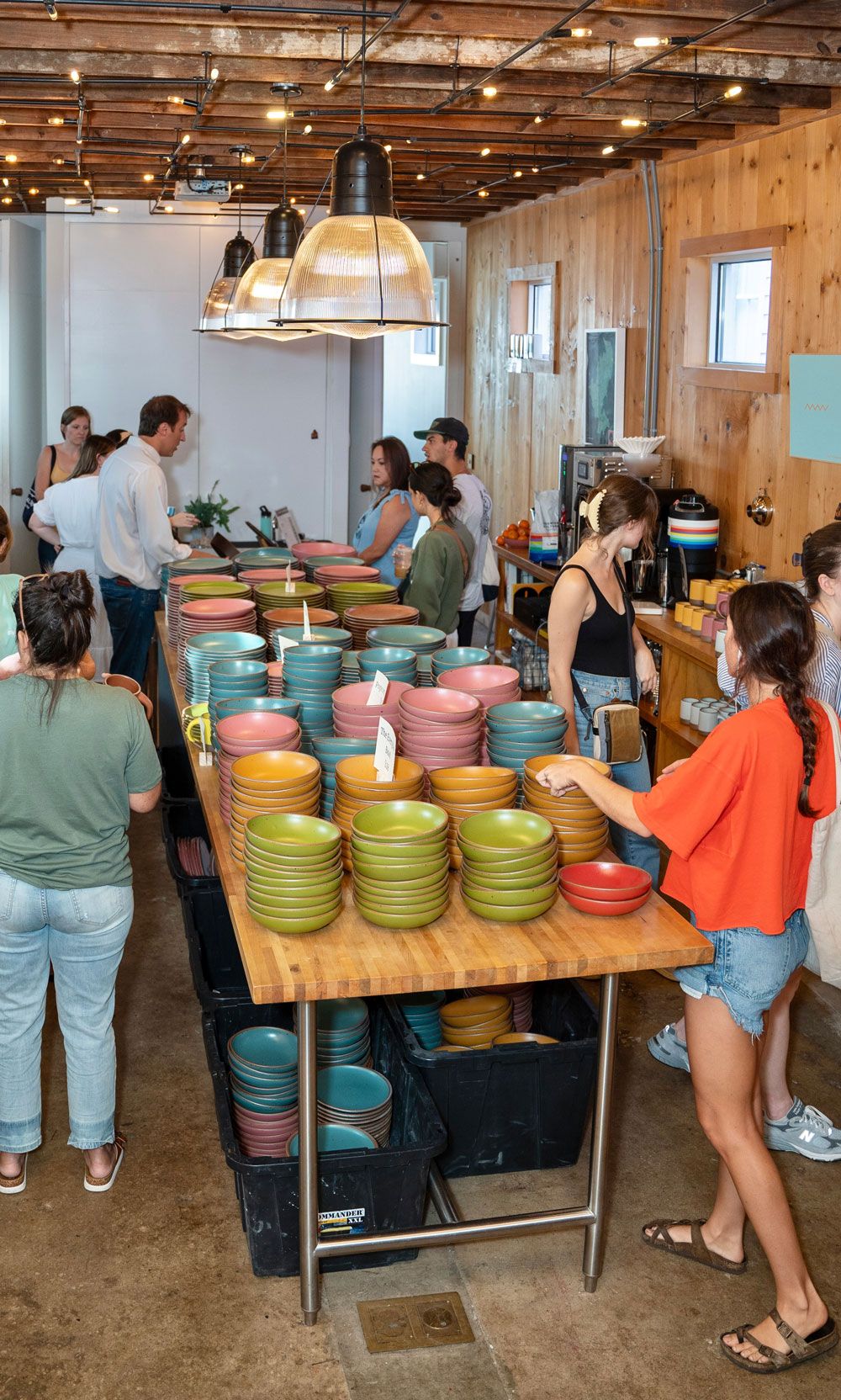 Lines of happy customers explore colorful stacks of East Fork "Seconds"