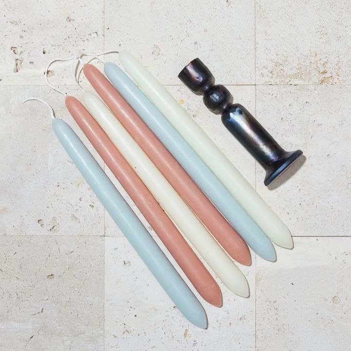 Terra Cotta, Ivory, and Blue candles lined up next to candle holder
