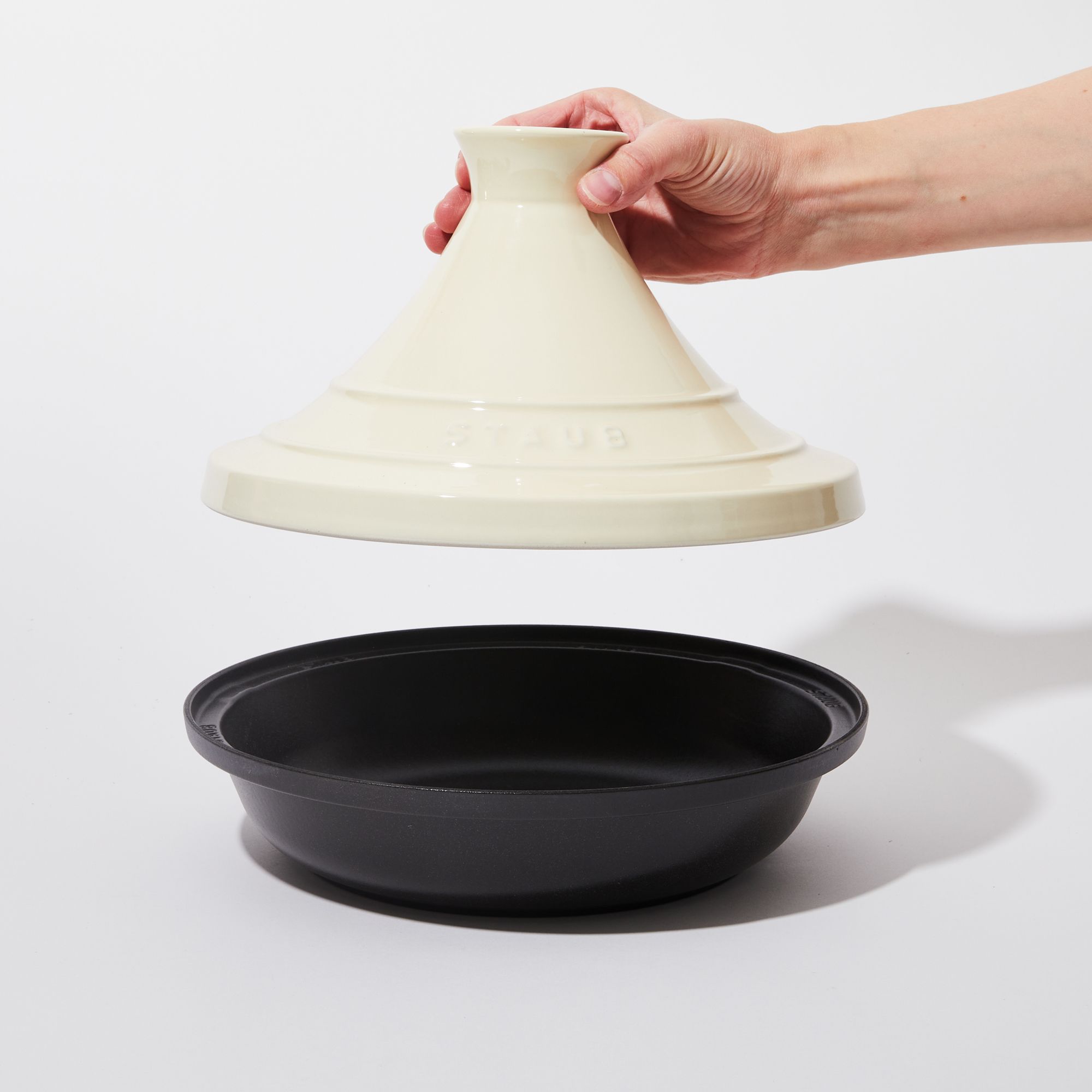 Ceramic Cream lid and black base with hand holding lid up