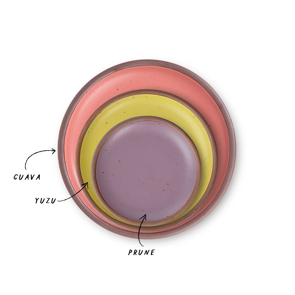 A stack of 3 plates in Dinner, Side, and Cake sizes in a watermelon pink, zesty yellow, and soft mauve purple colors.
