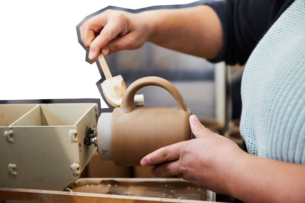 The handle is affixed to the mug body.
