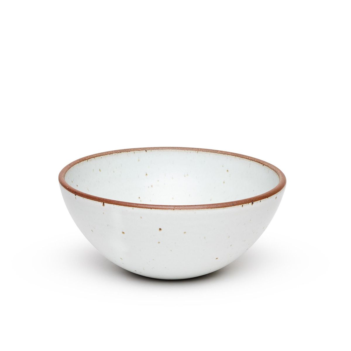 A large rounded ceramic bowl in a cool white color featuring iron speckles and an unglazed rim