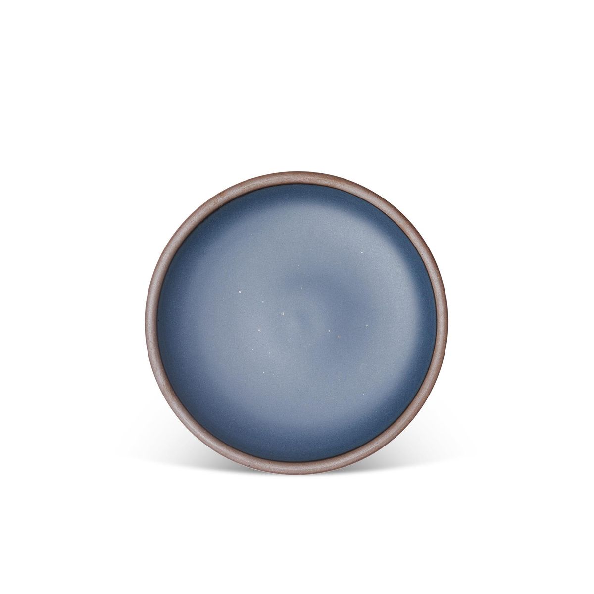 A medium sized ceramic plate in a toned-down navy color featuring iron speckles and an unglazed rim.