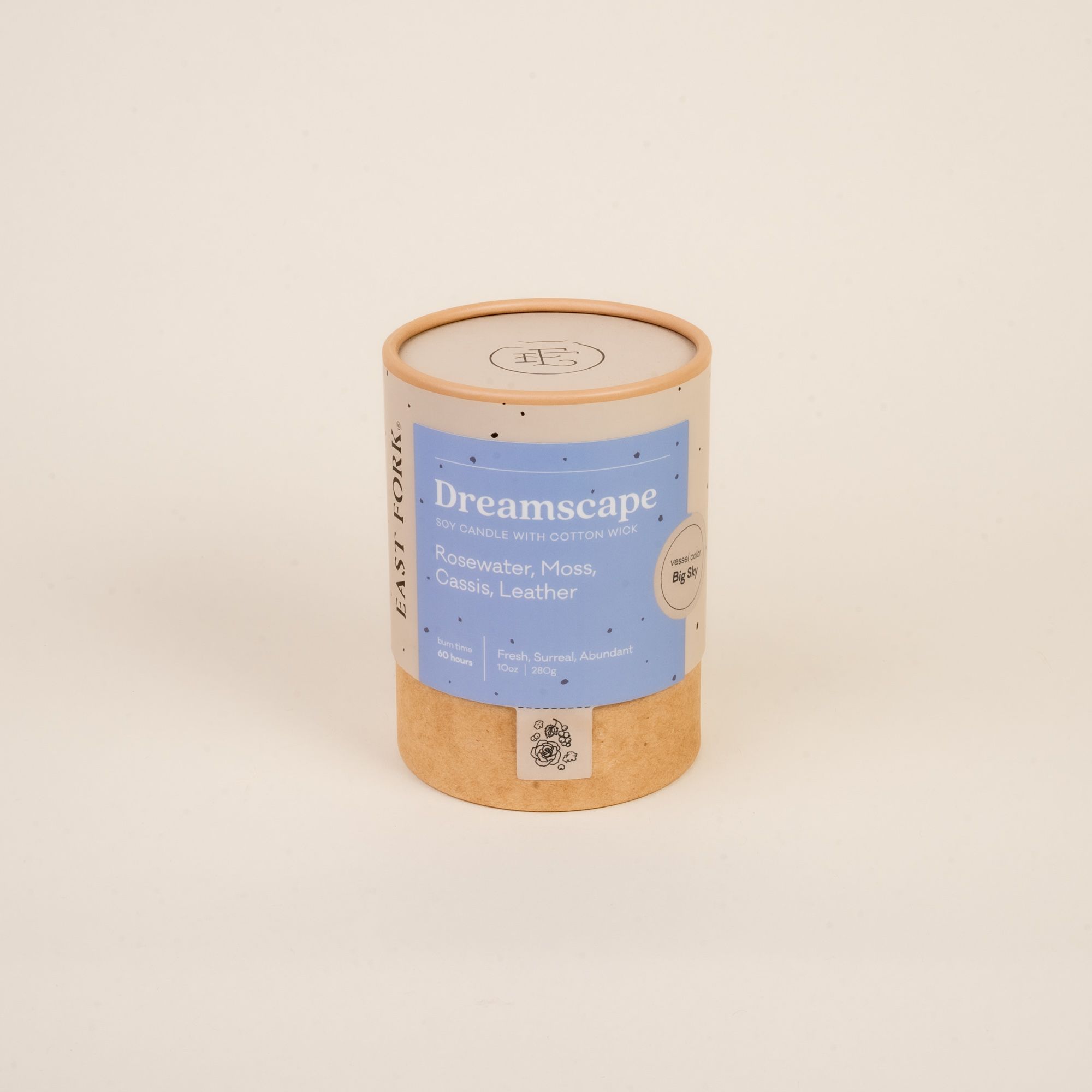 Large cardboard packaging tube with a candle inside with branding on it that says 'Dreamscape'