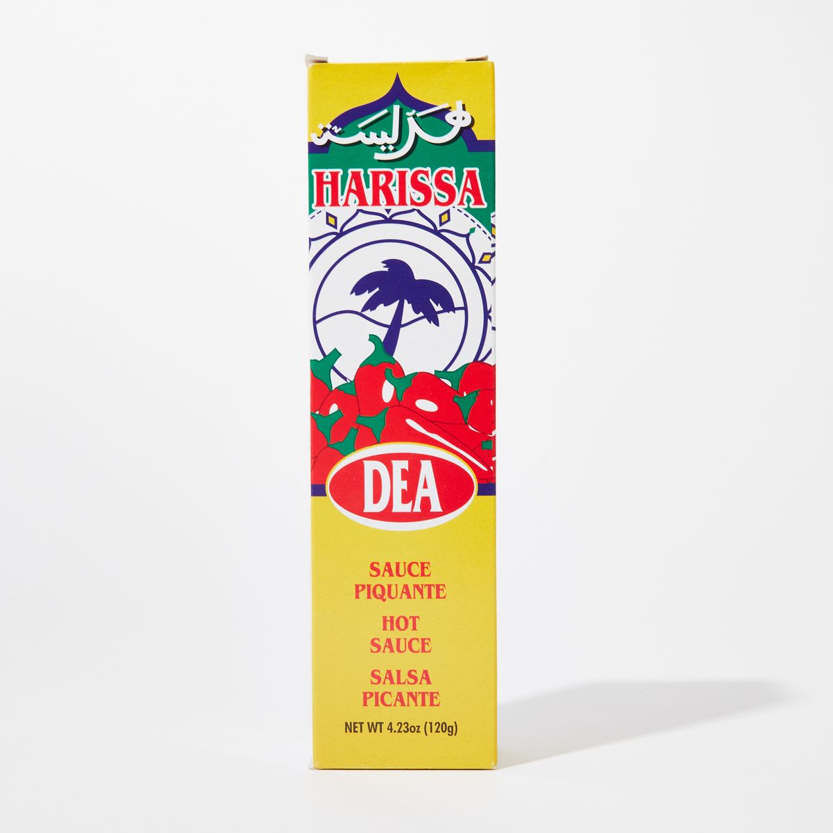 Yellow box with graphics of peppers and a palm tree that reads "Harissa" "Hot Sauce"