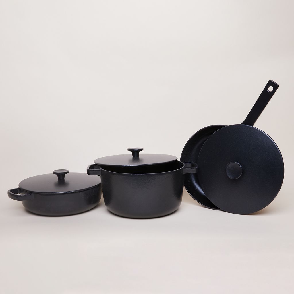 Pots of various sizes, all with lids and all made of black cast iron