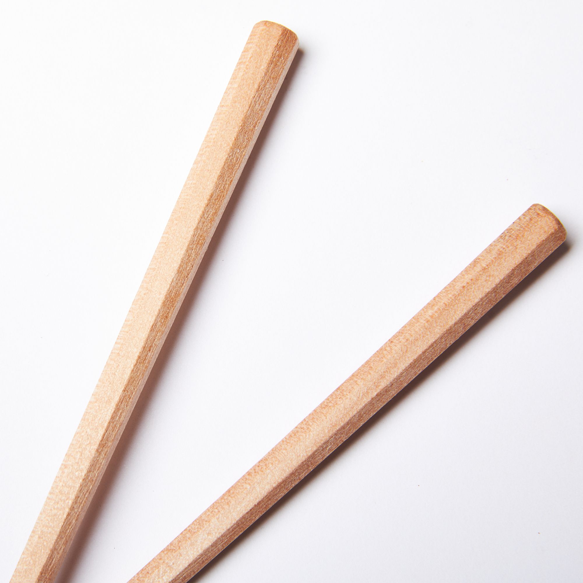 Tip of simple pair of light wood chopsticks