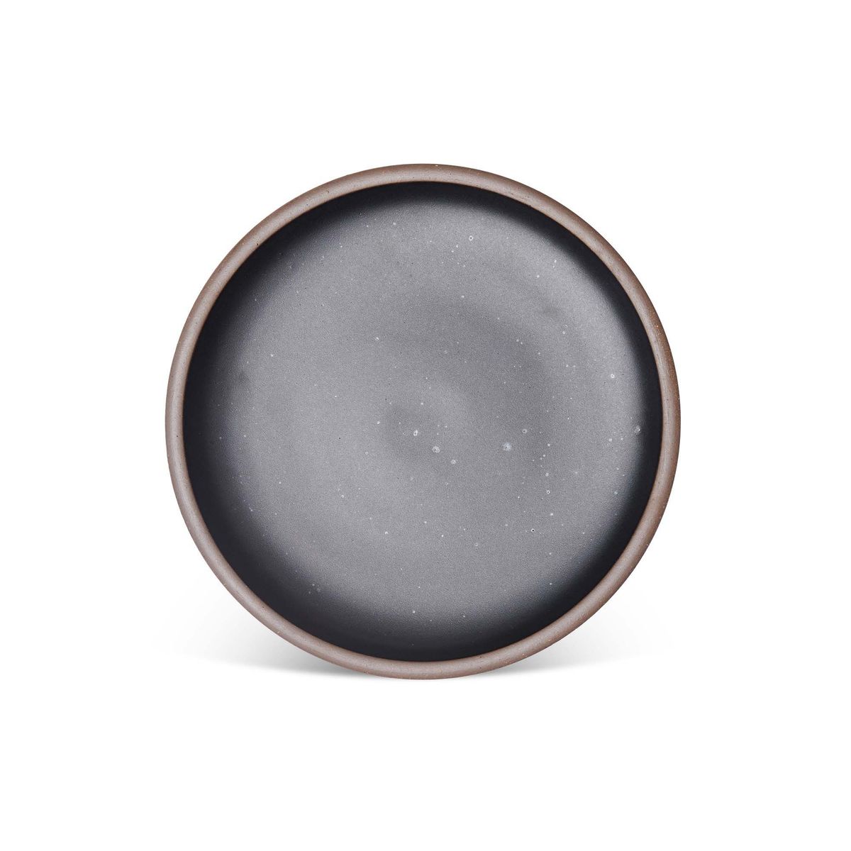 A dinner sized ceramic plate in a graphite black color featuring iron speckles and an unglazed rim