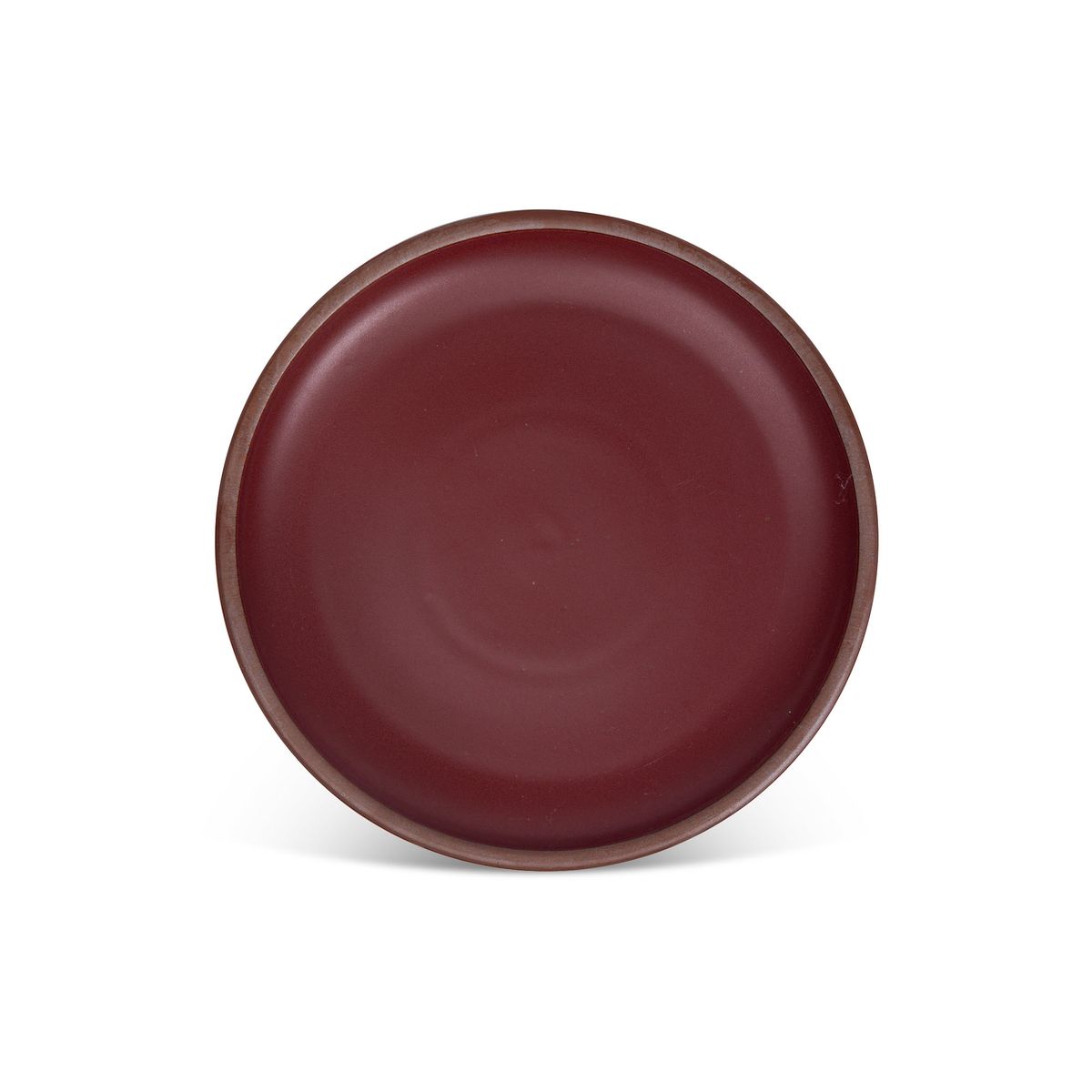 A dinner sized ceramic plate in a plum color featuring iron speckles and an unglazed rim