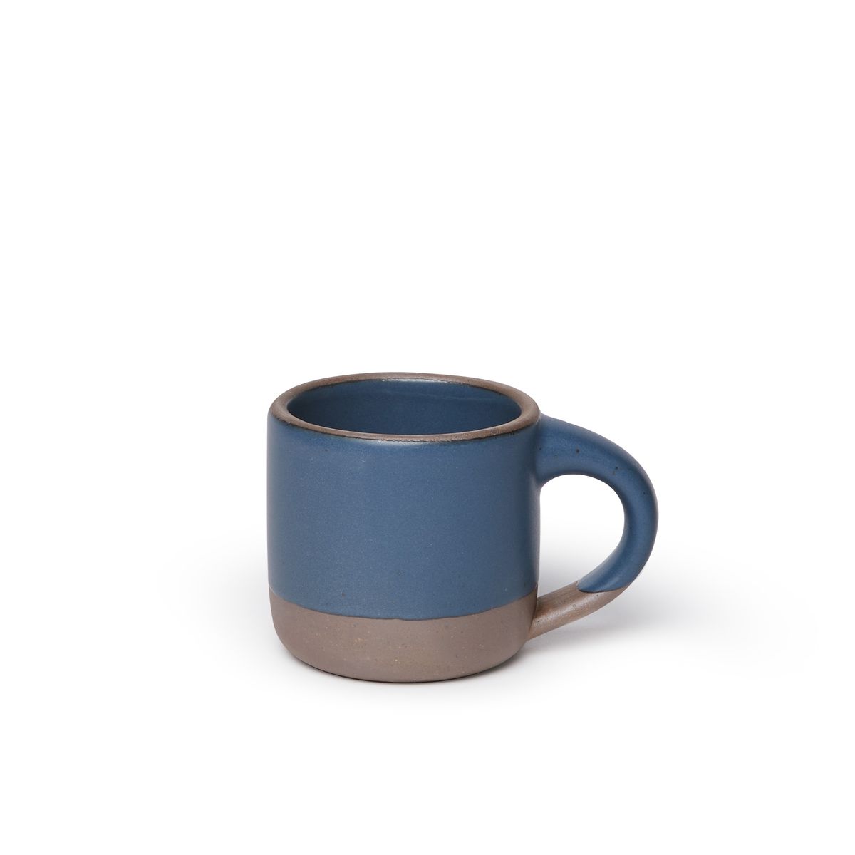 A small sized ceramic mug with handle in a toned-down navy glaze featuring iron speckles and unglazed rim and bottom base.