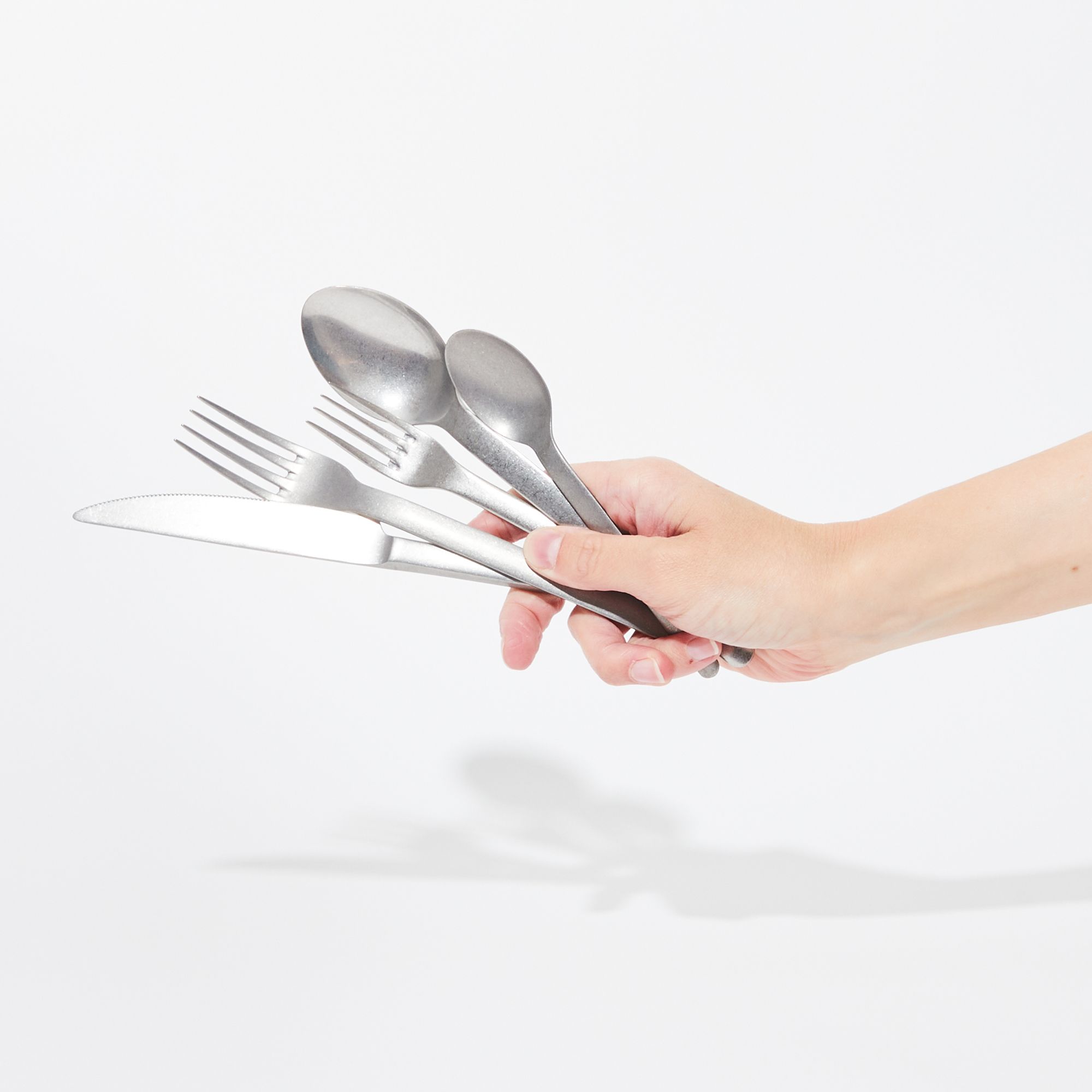 Hand holding Stainless steel flatware