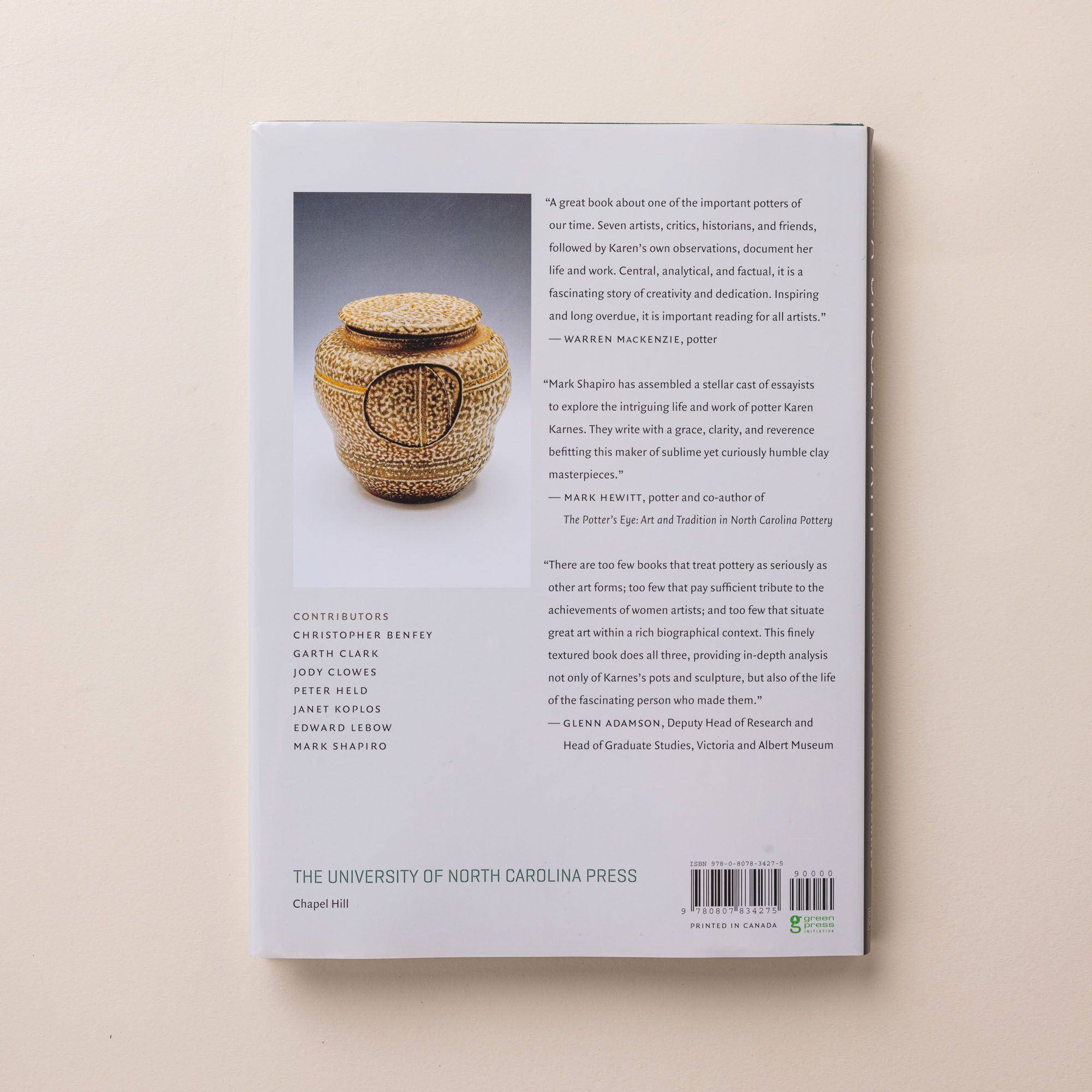 The back of a hardcover book called "A Chosen Path" and featurings ceramic pottery.