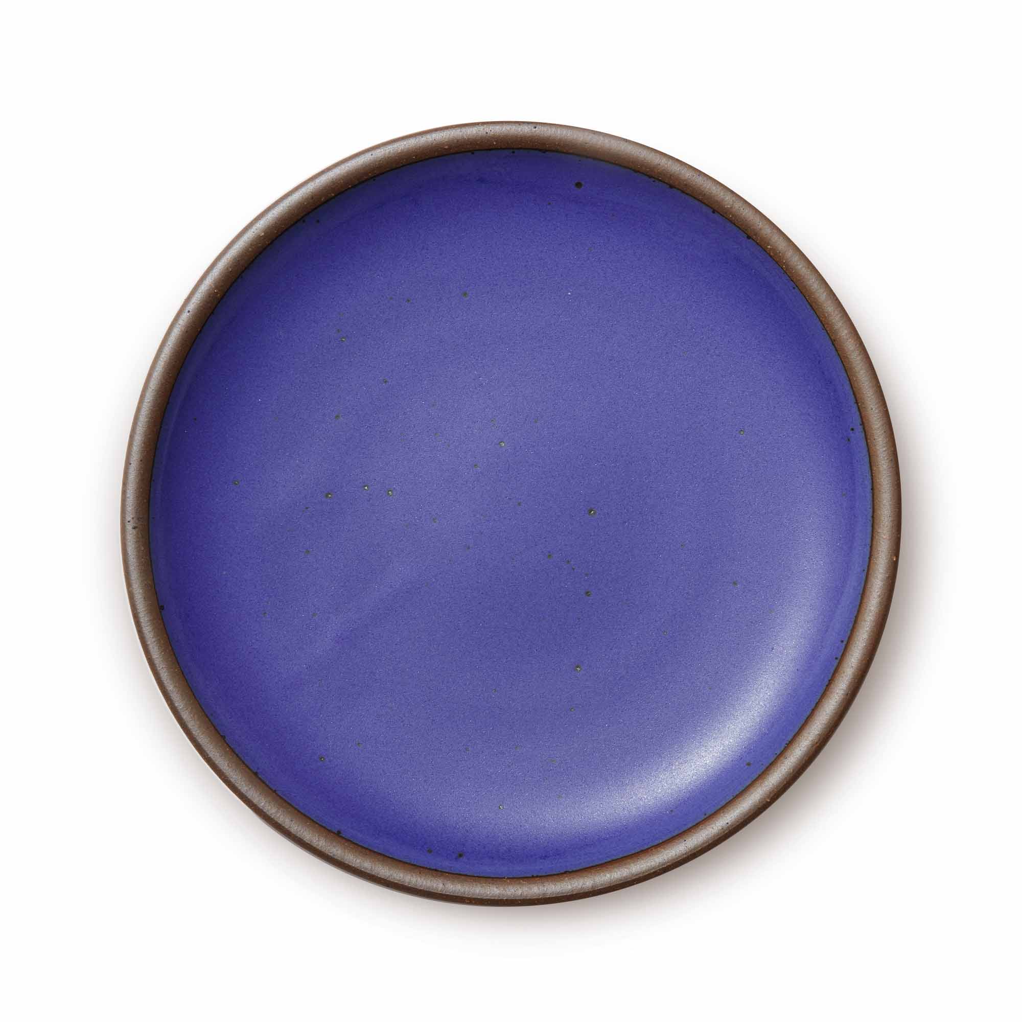 A large ceramic platter in a true, cool blue color featuring an unglazed rim.