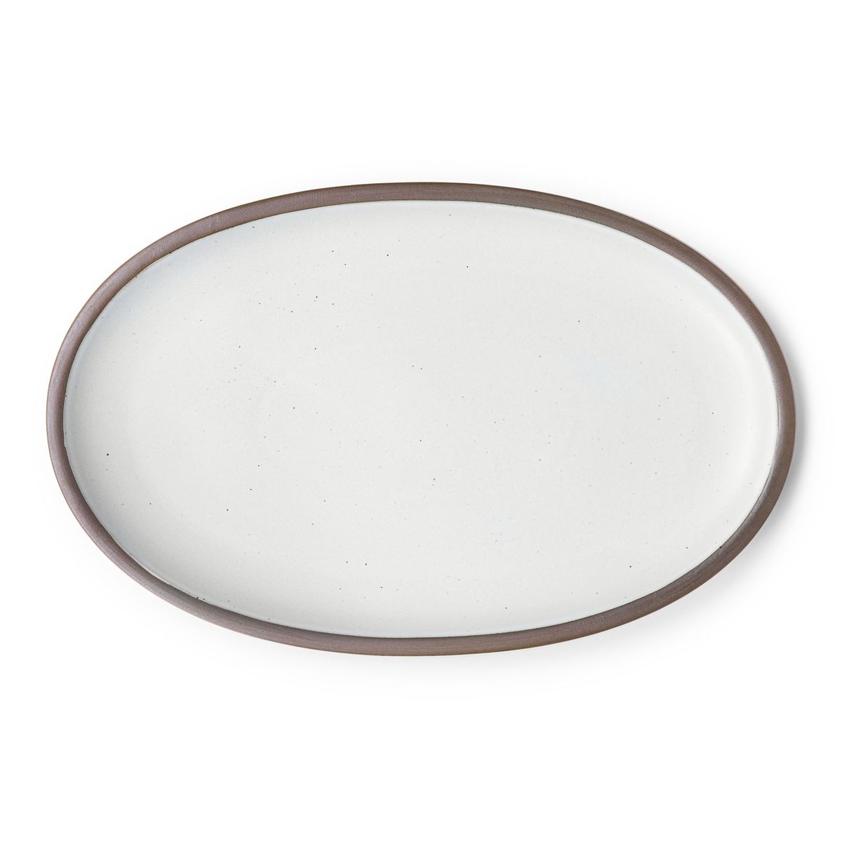 A large oval ceramic platter in a cool white color featuring iron speckles and an unglazed rim