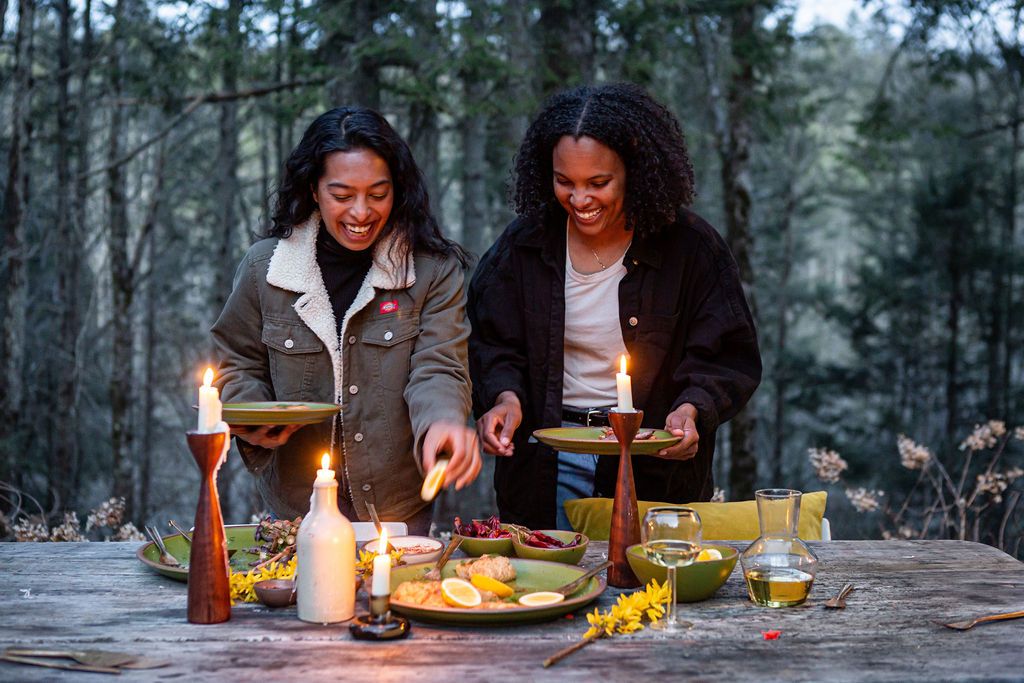 Standing at the dinner table with candles and plates