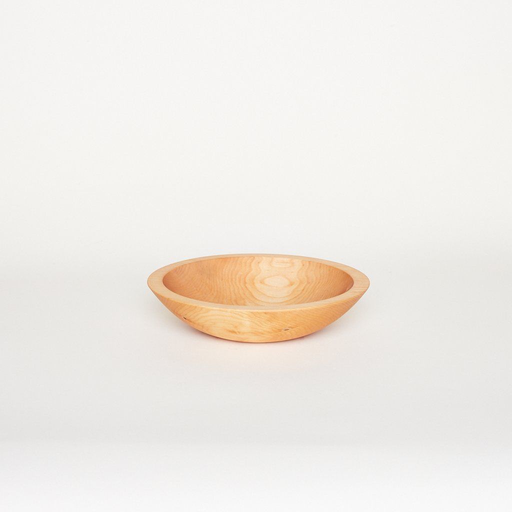 A small light-colored wooden bowl