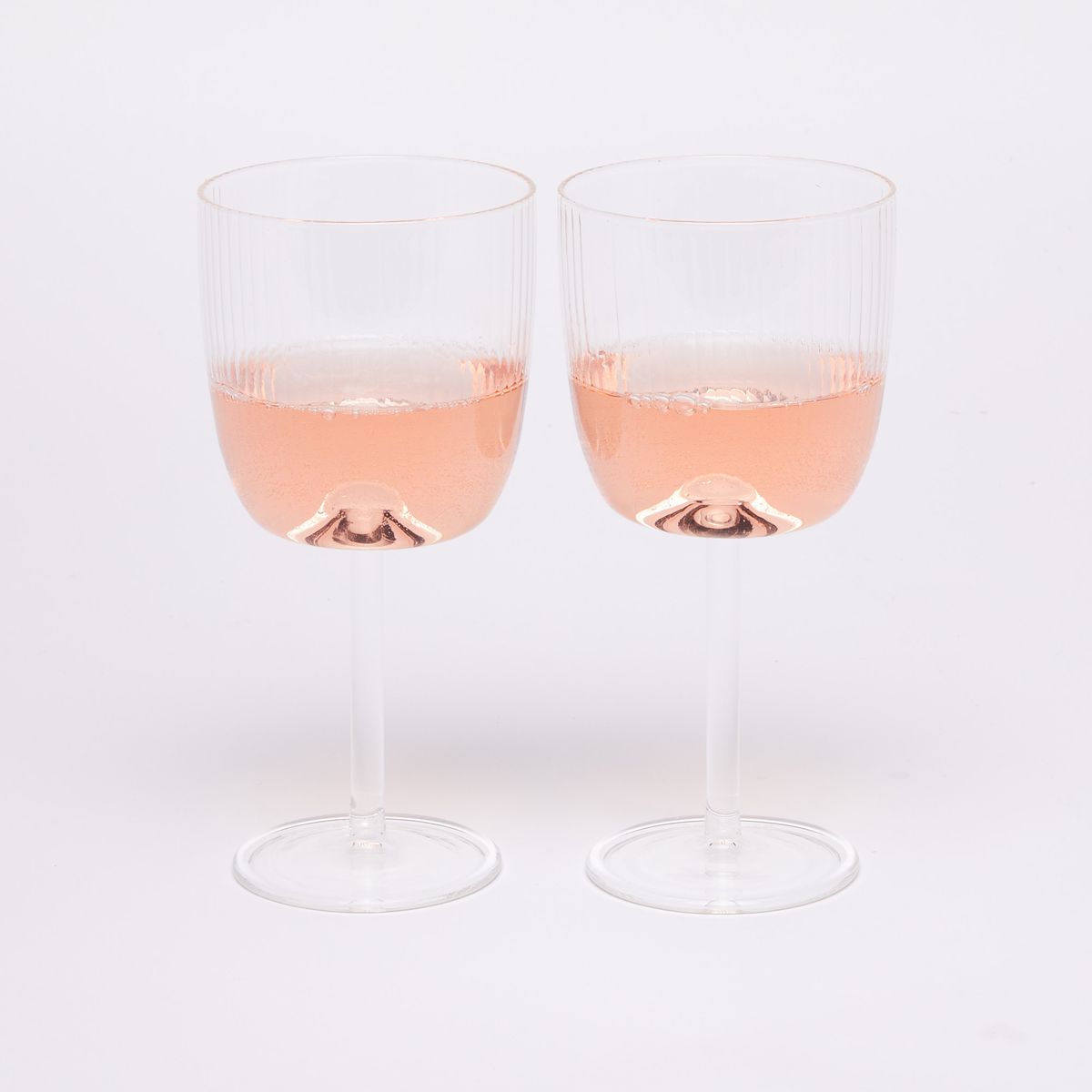 Two wine glasses with pink wine half full