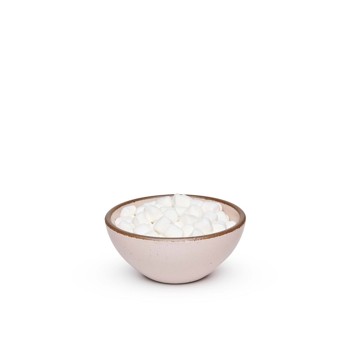A small dessert sized rounded ceramic bowl in a soft light pink color featuring iron speckles and an unglazed rim, filled with marshmallows