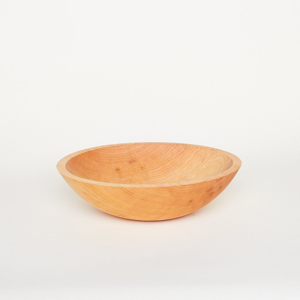 A medium-sized light-colored wooden bowl
