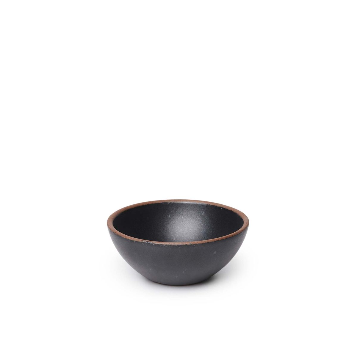 A small dessert sized rounded ceramic bowl in a graphite black color featuring iron speckles and an unglazed rim