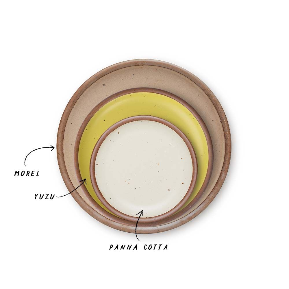 A stack of 3 plates in Dinner, Side, and Cake sizes in a warm pale brown, zesty yellow colors, and warm off-white.