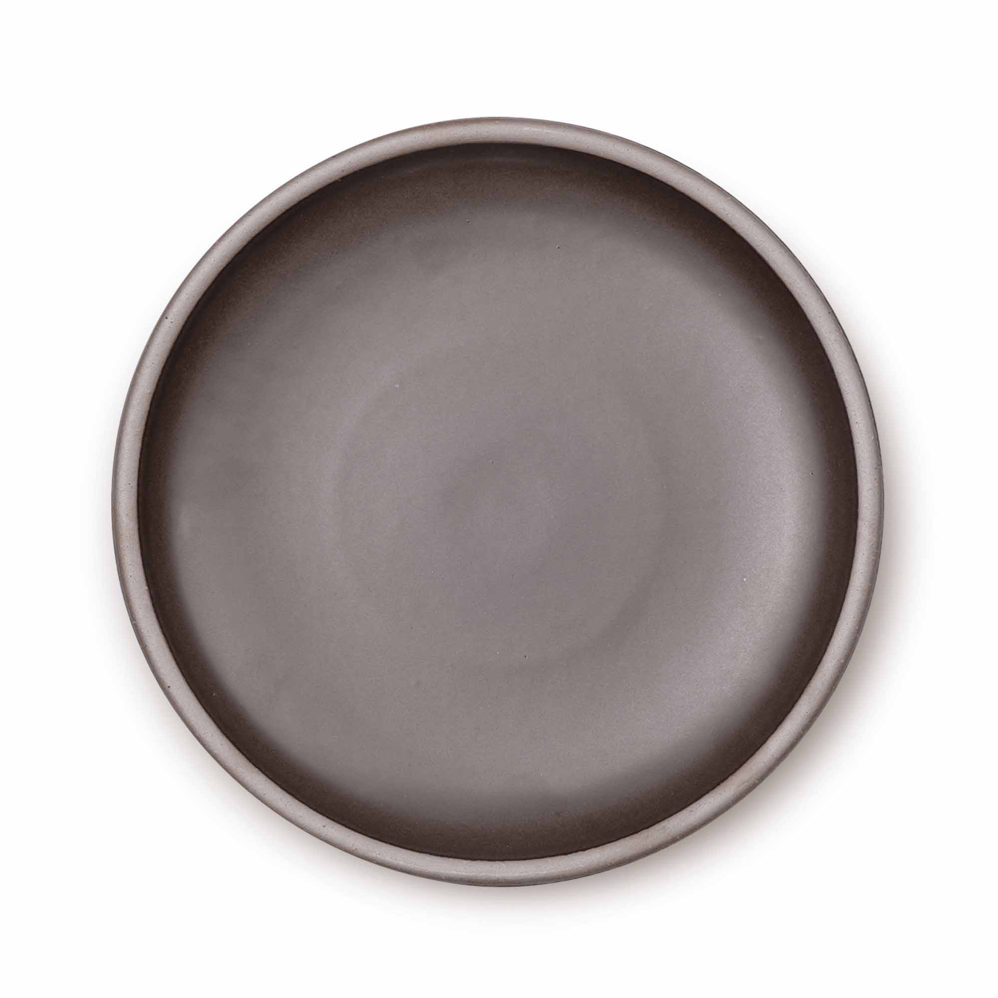A large ceramic platter in a dark brown color featuring an unglazed rim.