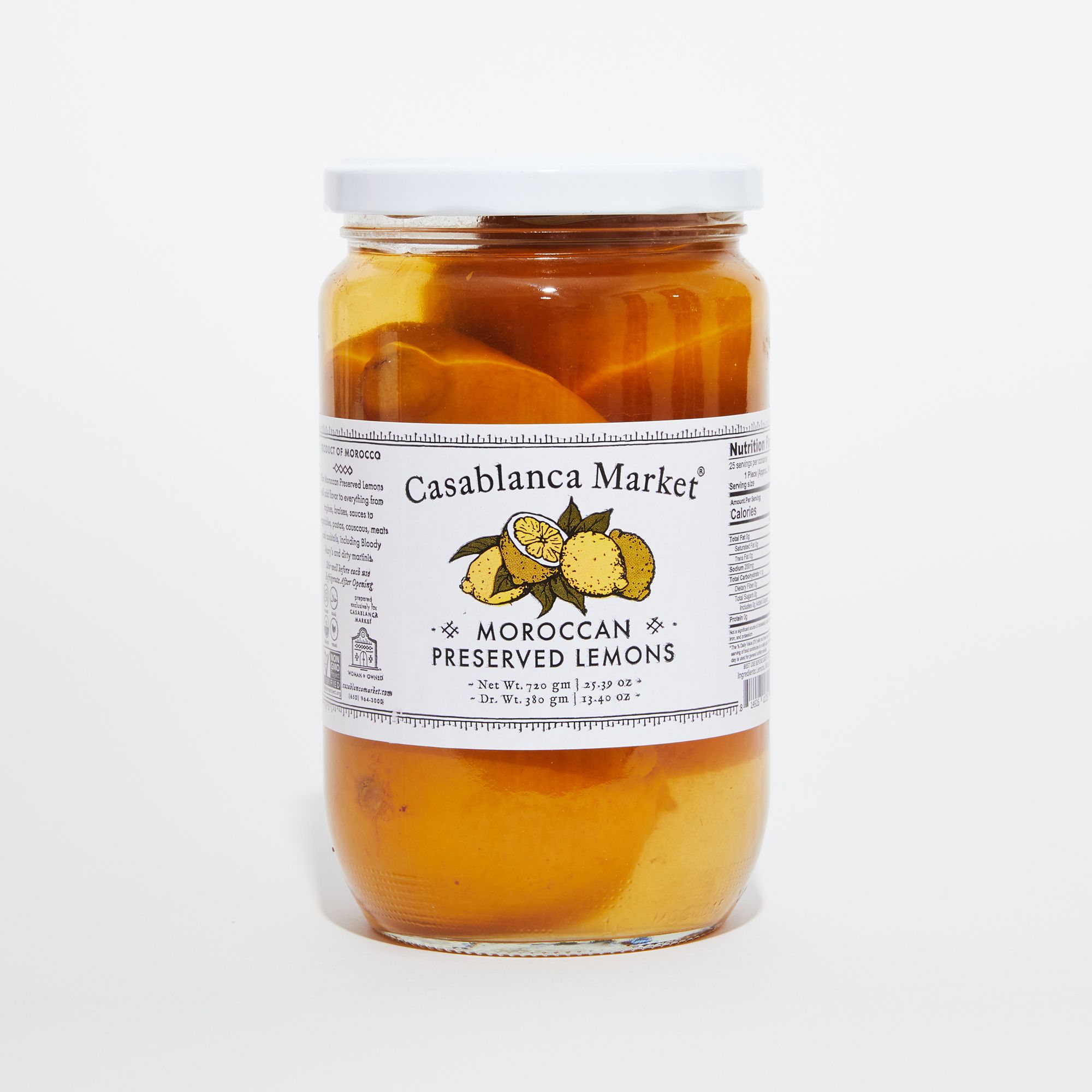 Clear jar with a white label containing preserved lemons in liquid