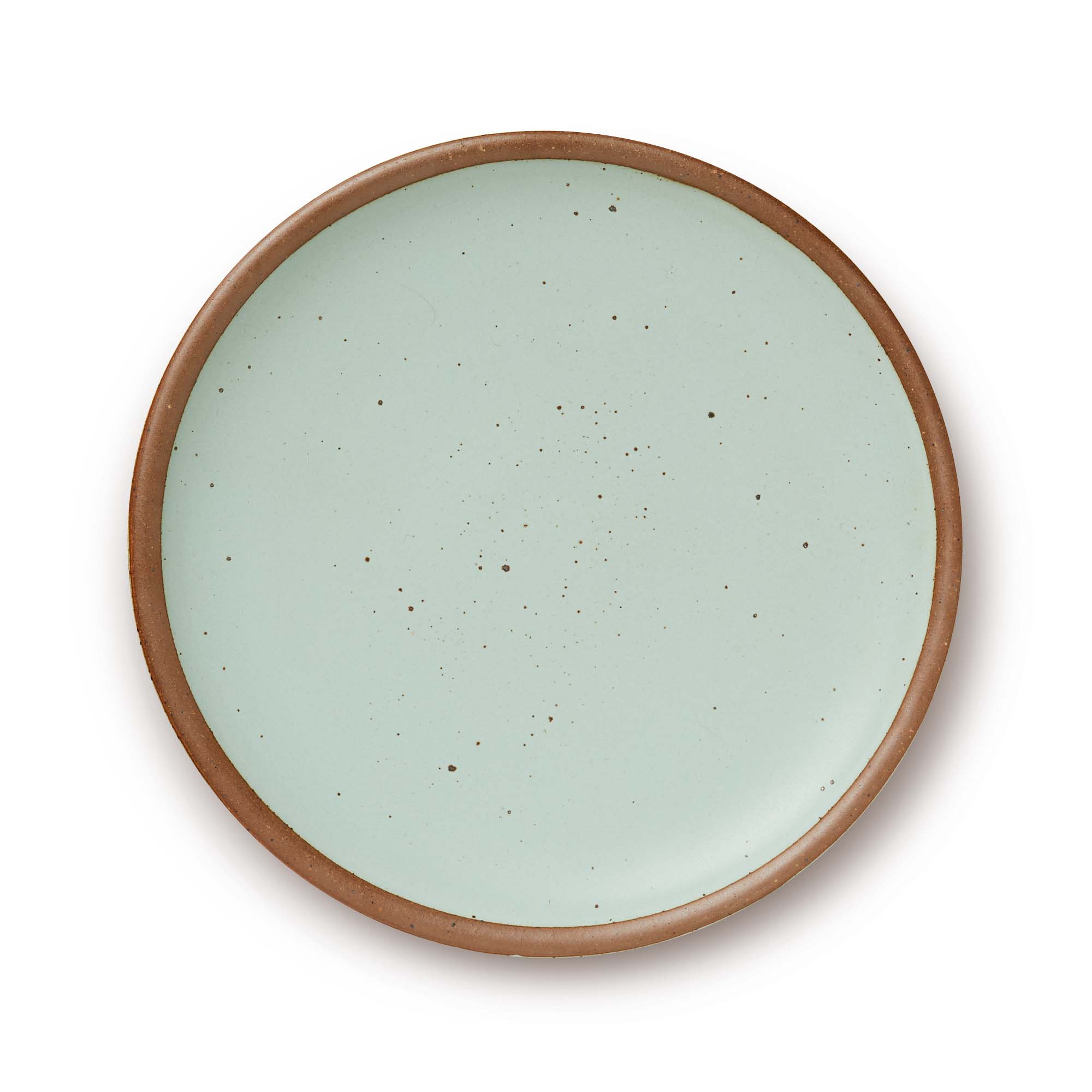 A large ceramic platter in a soft light aqua color featuring iron speckles and an unglazed rim.
