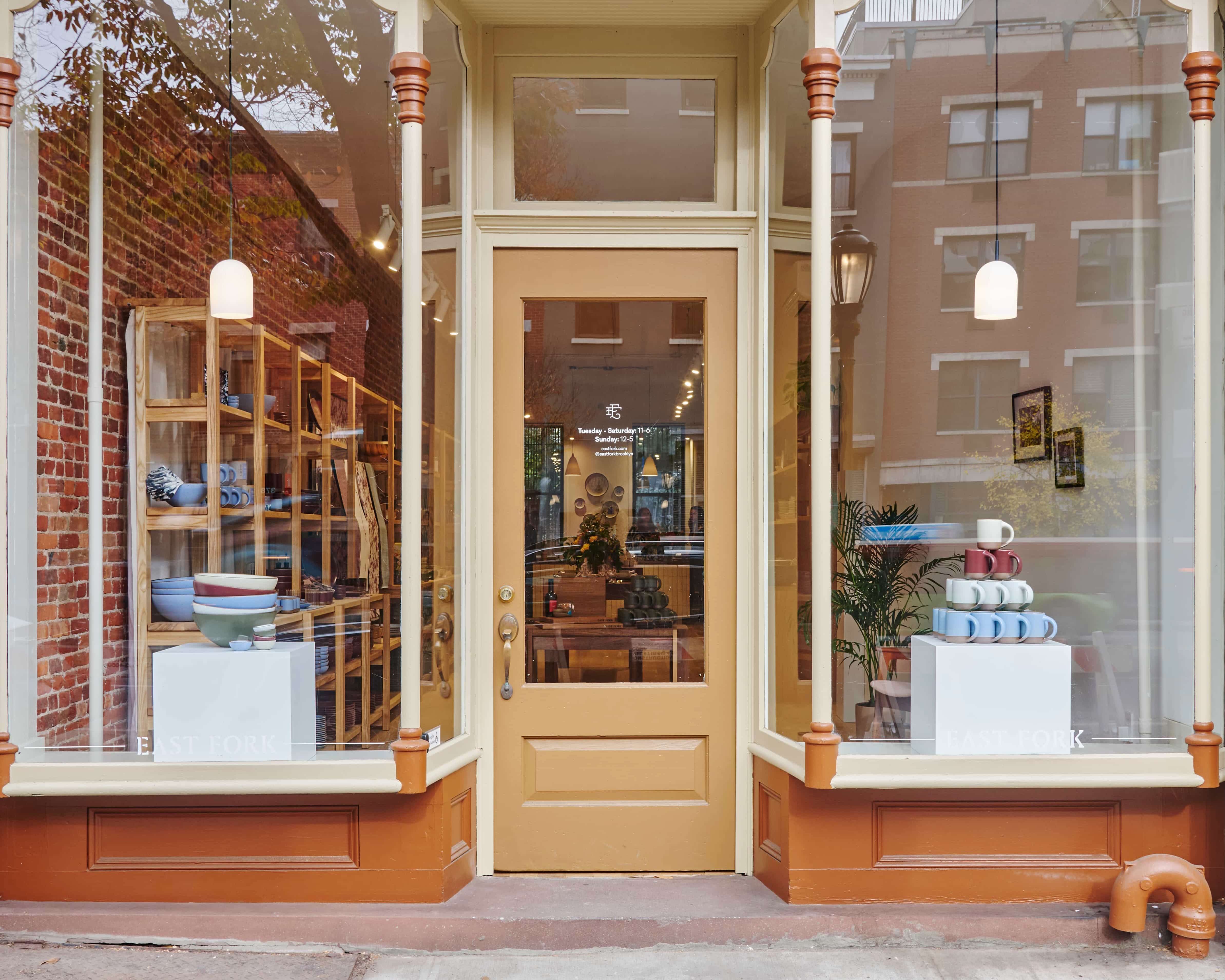 Exterior view of our East Fork Brooklyn storefront complete with 2 large windows and a brown door in the center