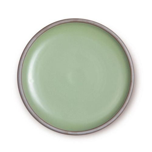 A dinner plate with a raw clay rim and light green interior