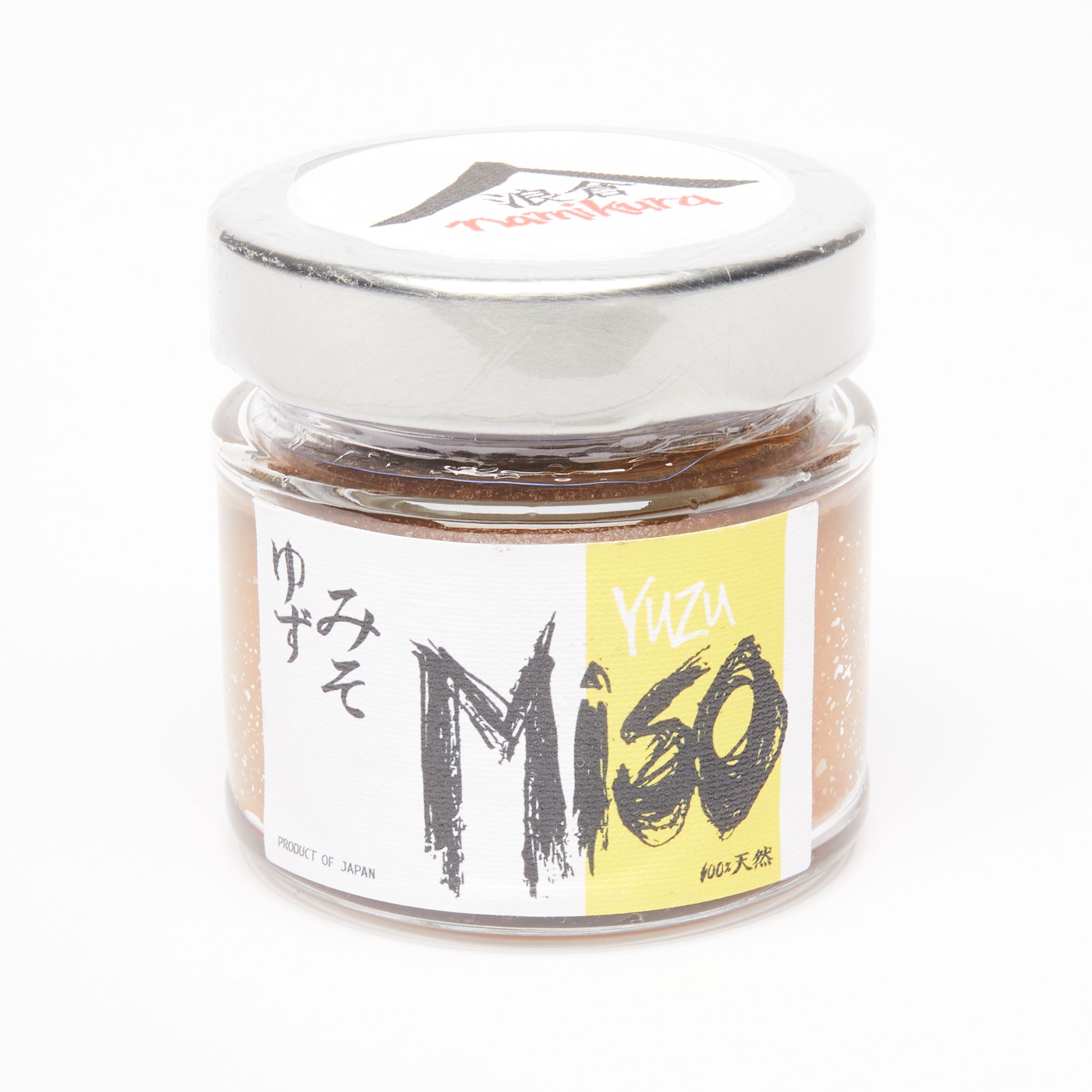 A small clear jar with a metal screw cap with a white and yellow label that reads "Miso".