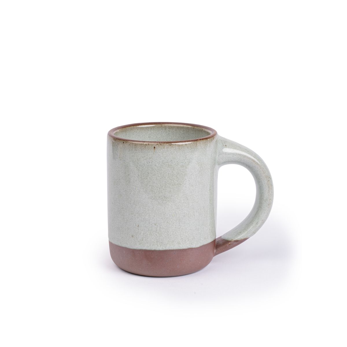A medium sized ceramic mug with handle in a reflective icy off-white color featuring iron speckles and unglazed rim and bottom base.