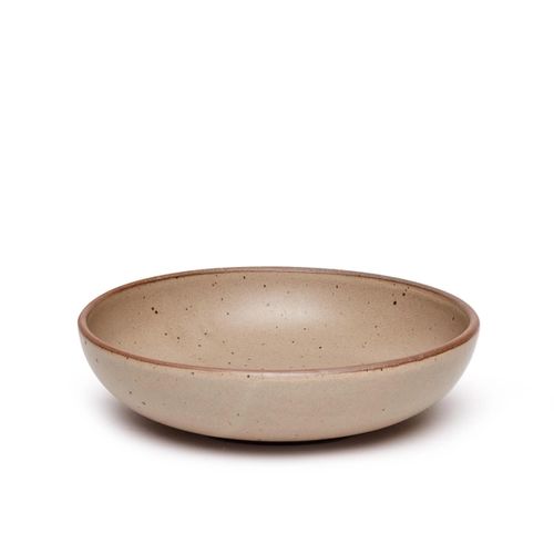 A large shallow serving ceramic bowl in a warm pale brown color featuring iron speckles and an unglazed rim