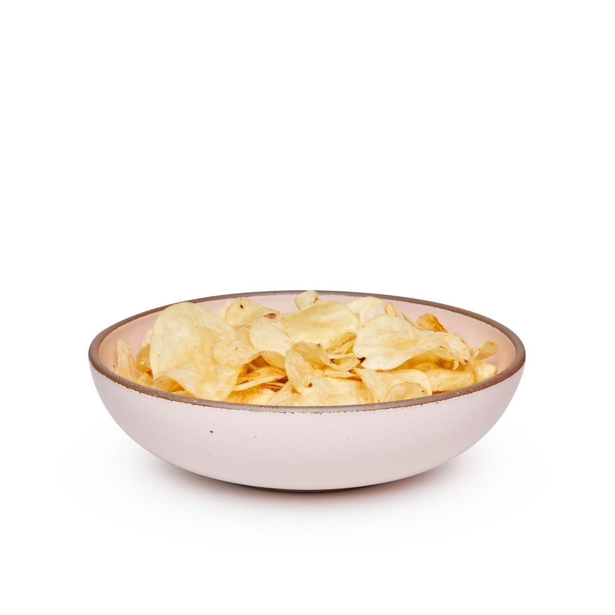 A large shallow serving ceramic bowl in a soft light pink color featuring iron speckles and an unglazed rim, filled with potato chips