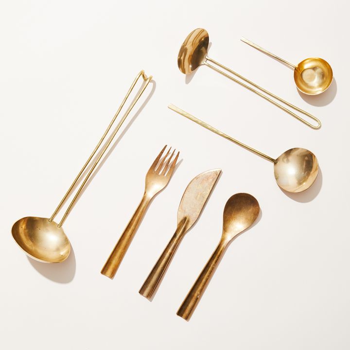 An assortment of stylish, beautiful, handmade brass cutlery and serving utensils made by Lue Brass