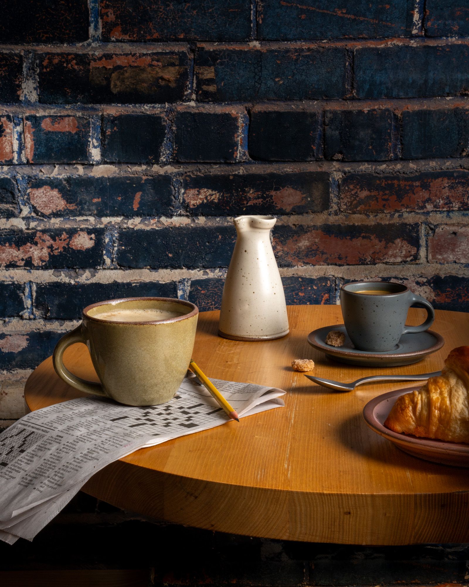 A table with East Fork Workshop pieces, The Sunday Morning Mug, The Creamer, the Espresso Cup and Saucer.