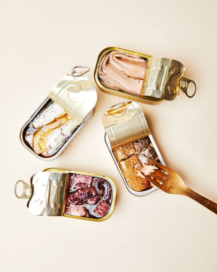 Four open cans of fish tins