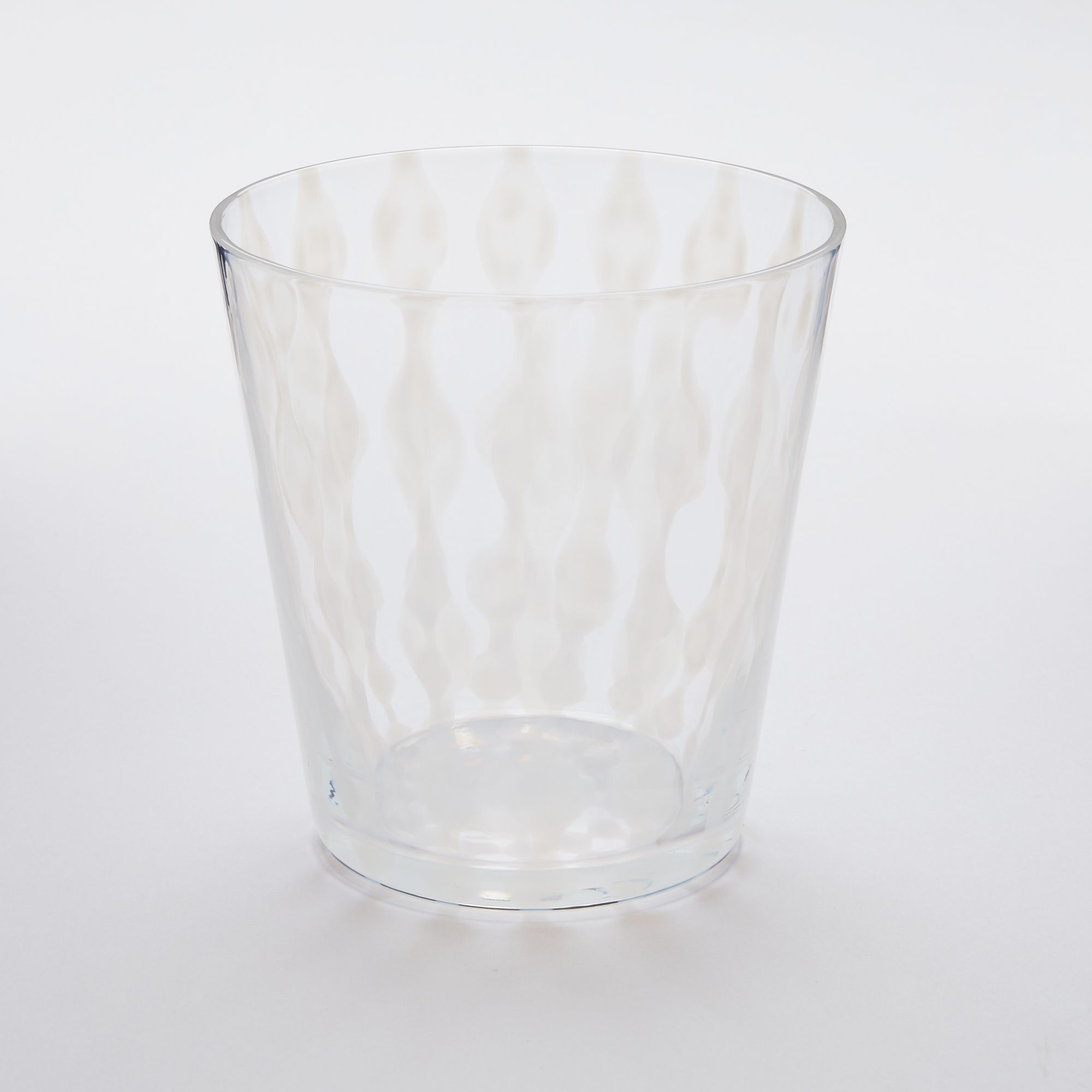 A short clear glass with a delicate vertical wave pattern