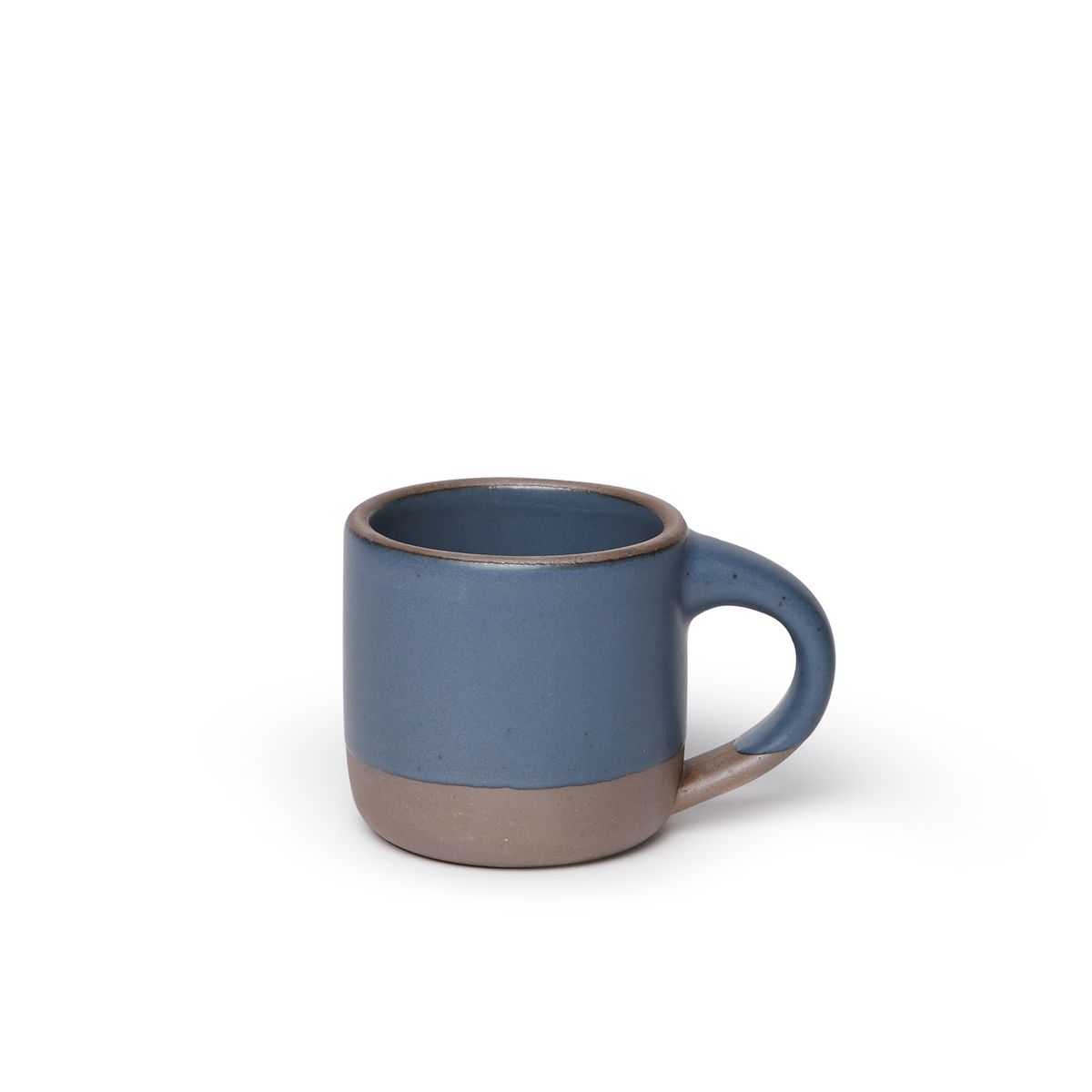 A small sized ceramic mug with handle in a cool medium blue glaze featuring iron speckles and unglazed rim and bottom base.