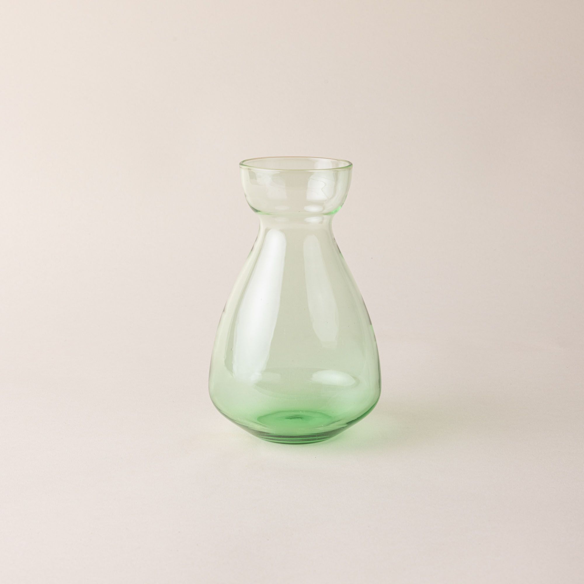 A green simple sculptural glass bulb vase.