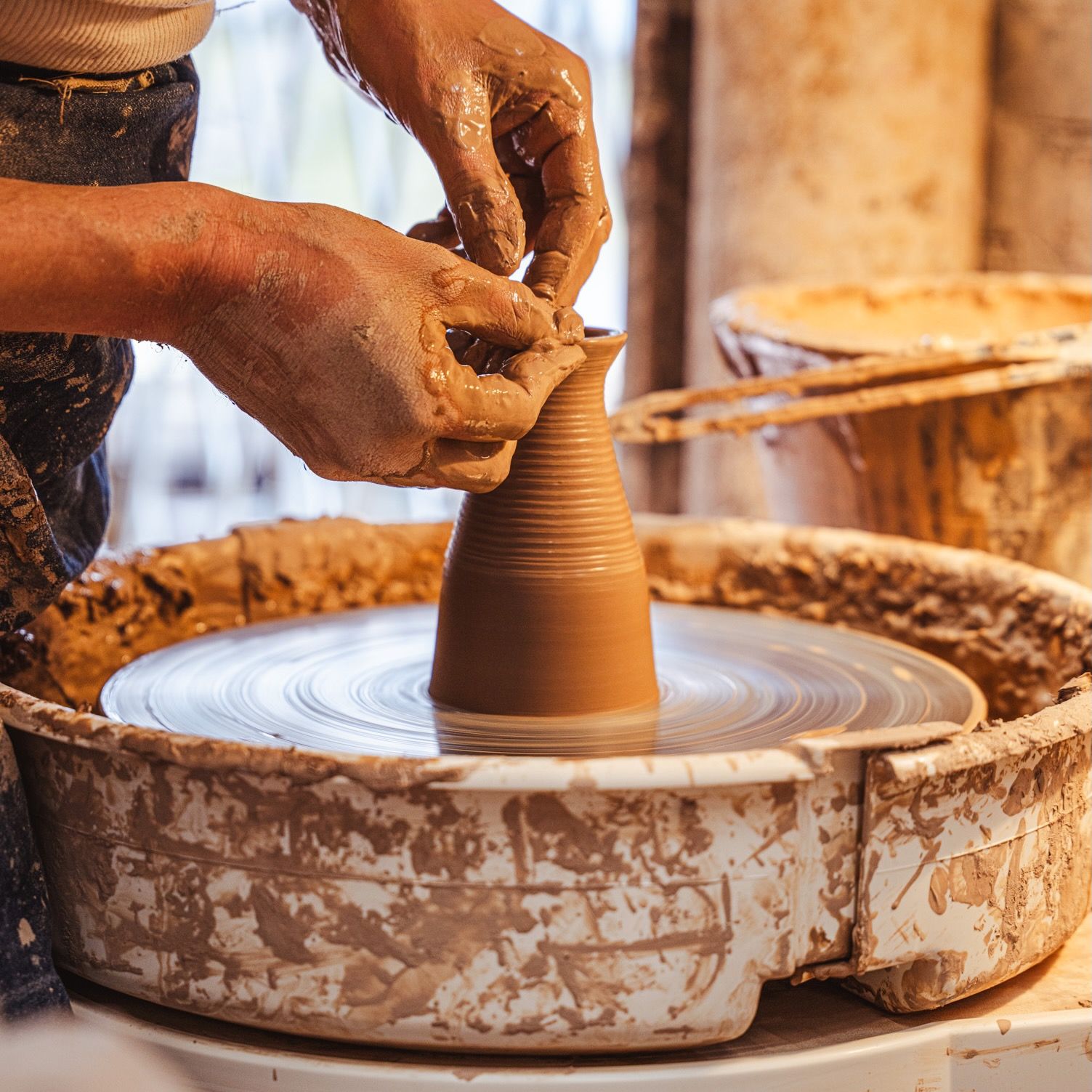 John forming the Creamer on the potter's wheel.