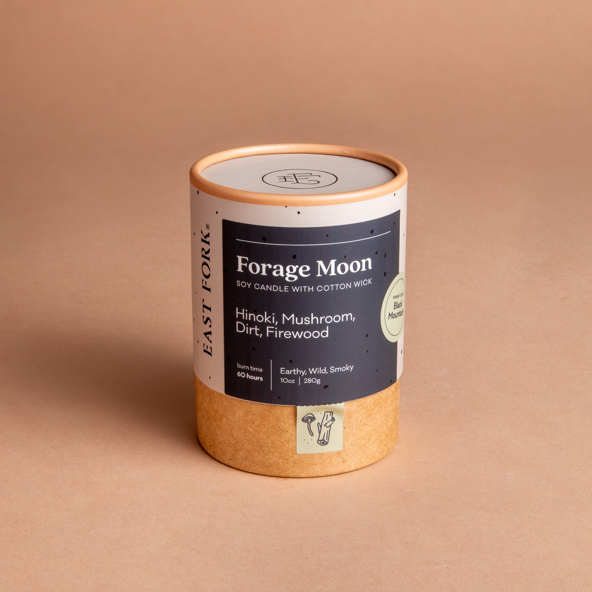 Large cardboard packaging tube with a candle inside with branding on it that says 'Forage Moon'