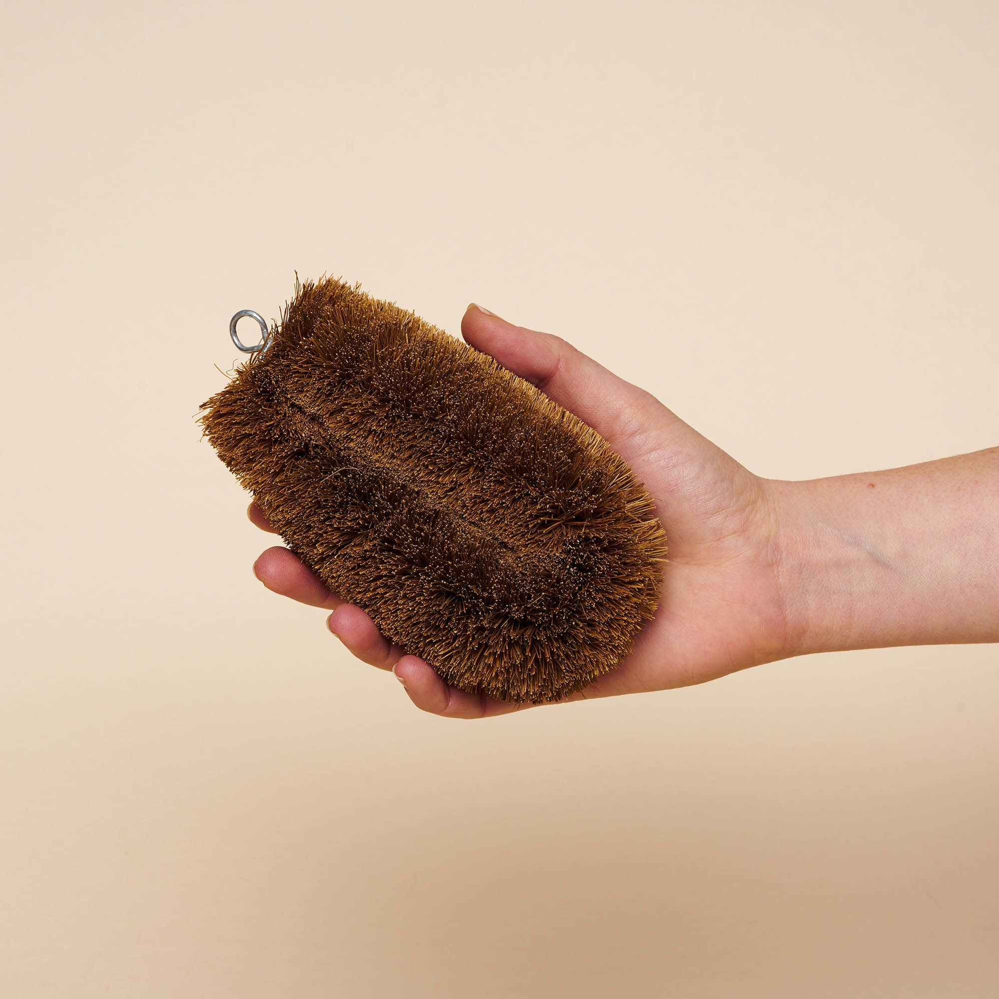 Natural hemp fiber scrub brush, oblong and dark brown with bristles